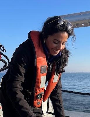 Mariam wearing a life jacket on a research vessel.