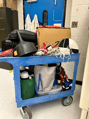 A blue cart filled entirely with various pieces of sampling equipment.